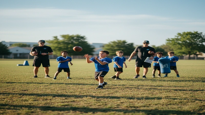Youth football players training with coaches on field
